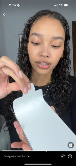 Vrouw plaatst screenprotector op smartphone, close-up, refurbished iPhone accessoire.